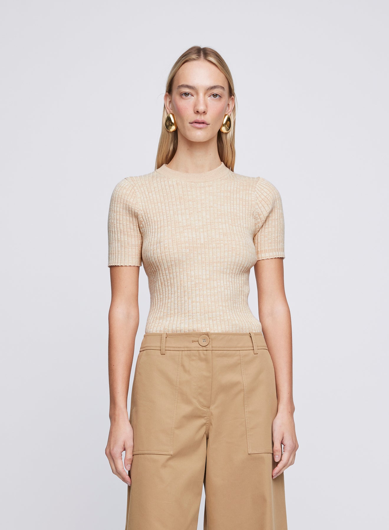 The Anna Quan Bebe Top in Sand Dune is an essential 100% cotton ribbed knit top with a crew neckline and subtle contrast trim.