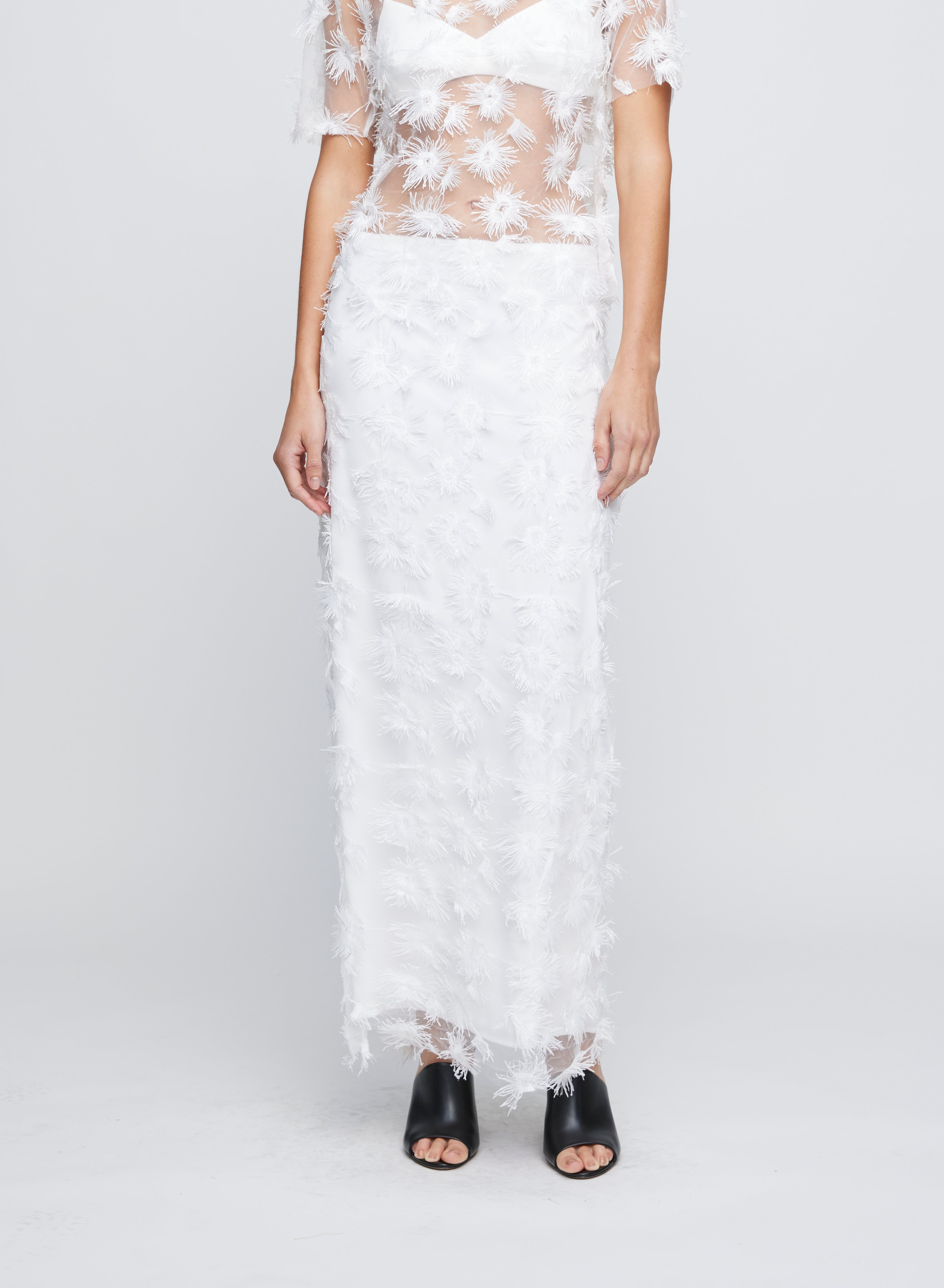 The Anna Quan Carmela Skirt in Dandelion is the perfect romantic occasion piece that sits mid to high on the waist and cut in a a sheer fabric with applique detailing.