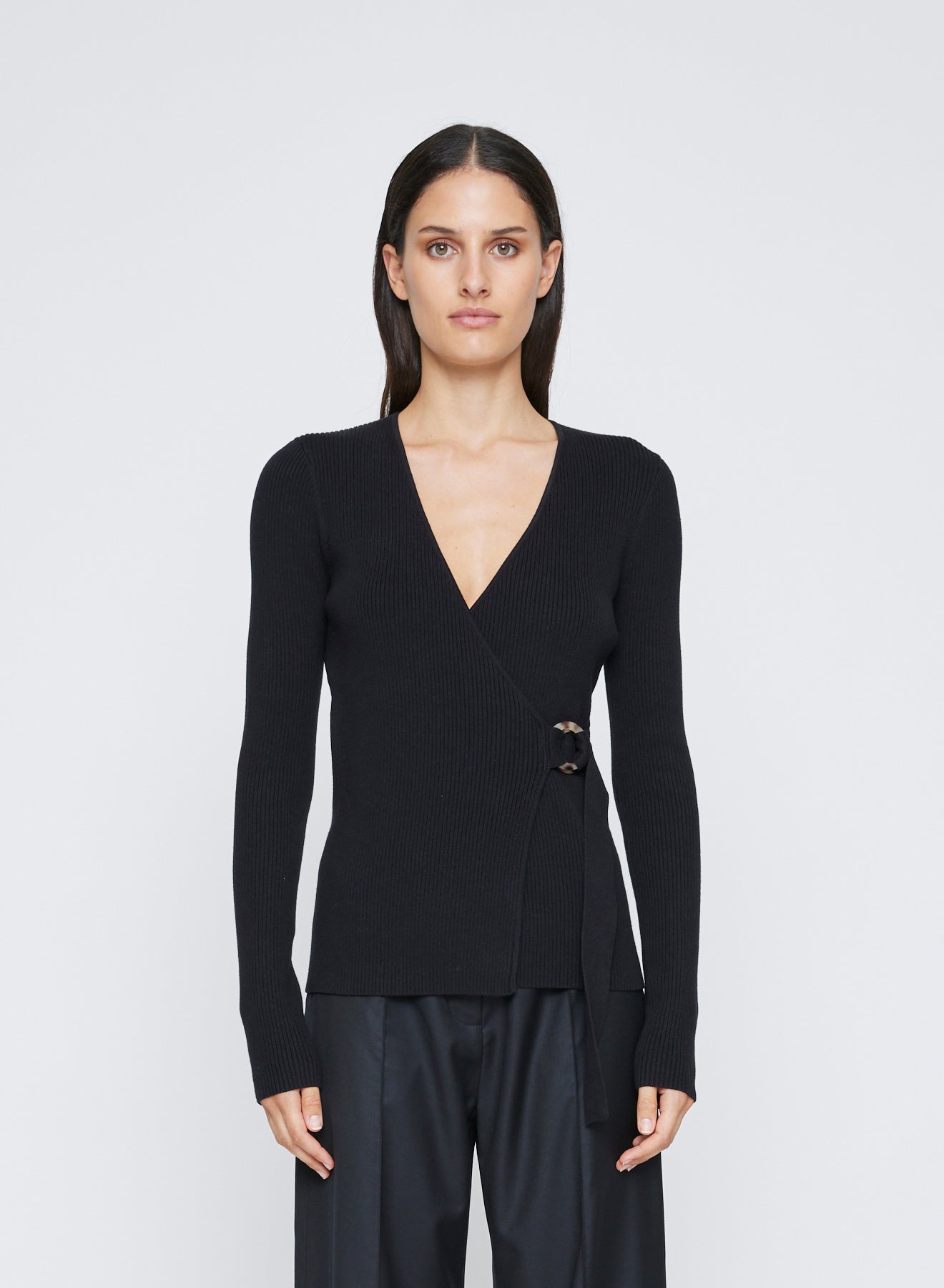 The Anna Quan Bonnie Top in Raven is a classic long sleeve knitted top with a belt closure and deep v cut neckline.