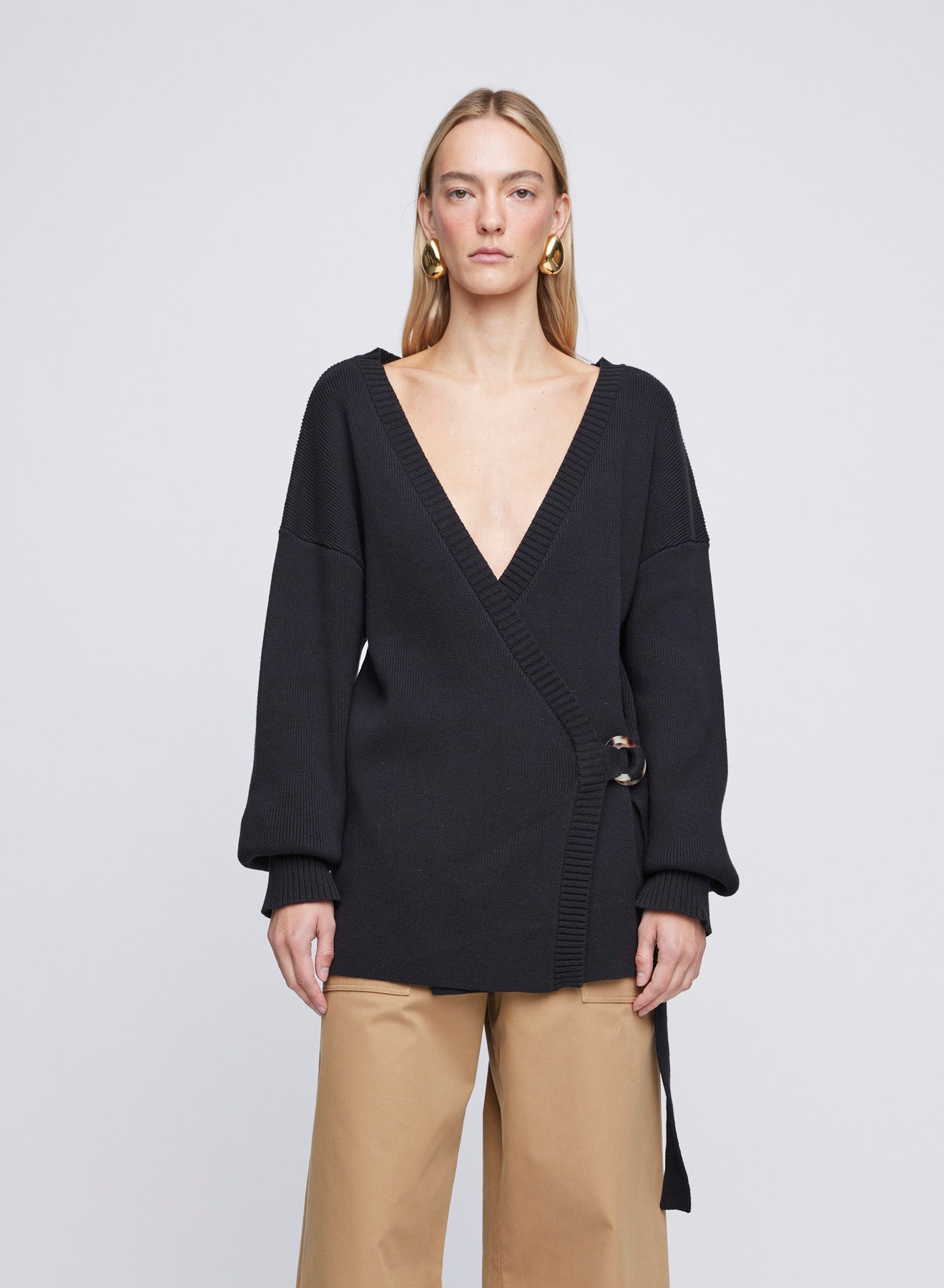 The ANNA QUAN Bridget Cardigan in Raven is a classic long sleeve knitted cardigan with a belt closure and deep v cut neckline.