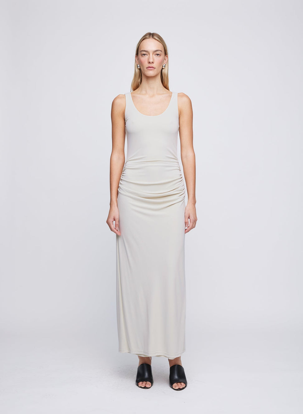 The ANNA QUAN Shelley Dress in Dove is designed in a jersey stretch material with a scoop neckline and subtle draping across the body for a flattering silhouette.