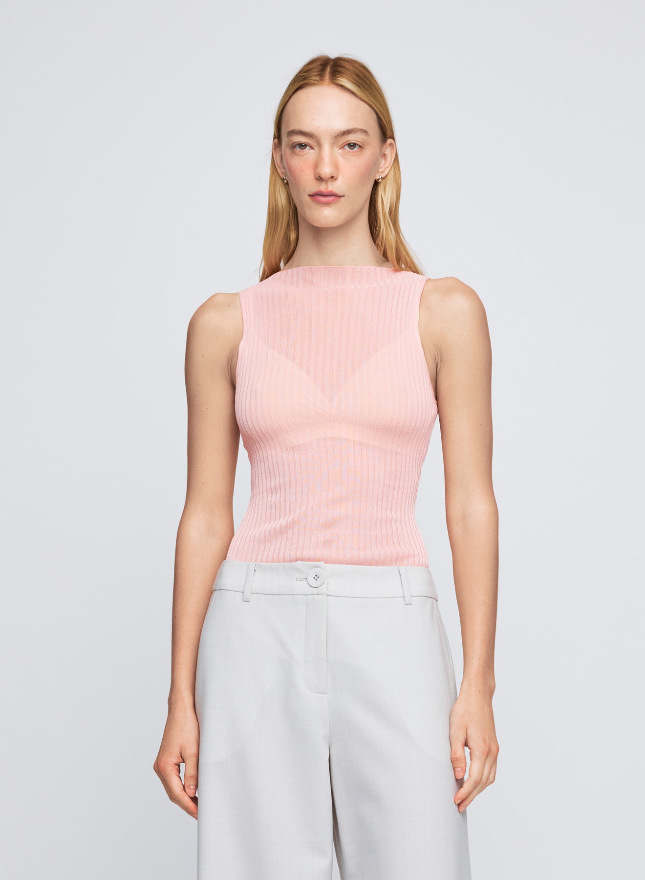 The ANNA QUAN Petra Top in Sakura is an elevated essential, crafted in a sheer knit material. Featuring a wide high neckline and sleeveless design for effortless layering.