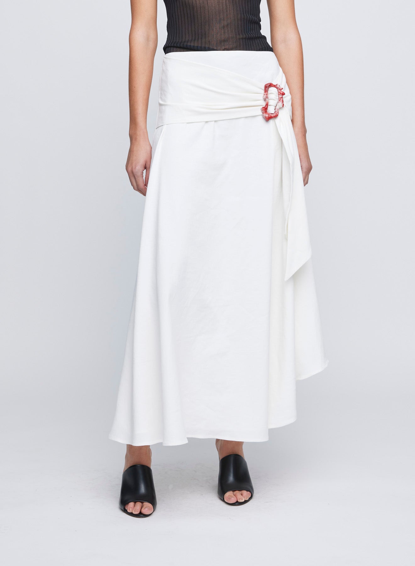 The ANNA QUAN Ingrid Skirt in Ivory Linen an asymmetrical midi style with an adjustable tie and textured buckle at the hip for a point of difference.